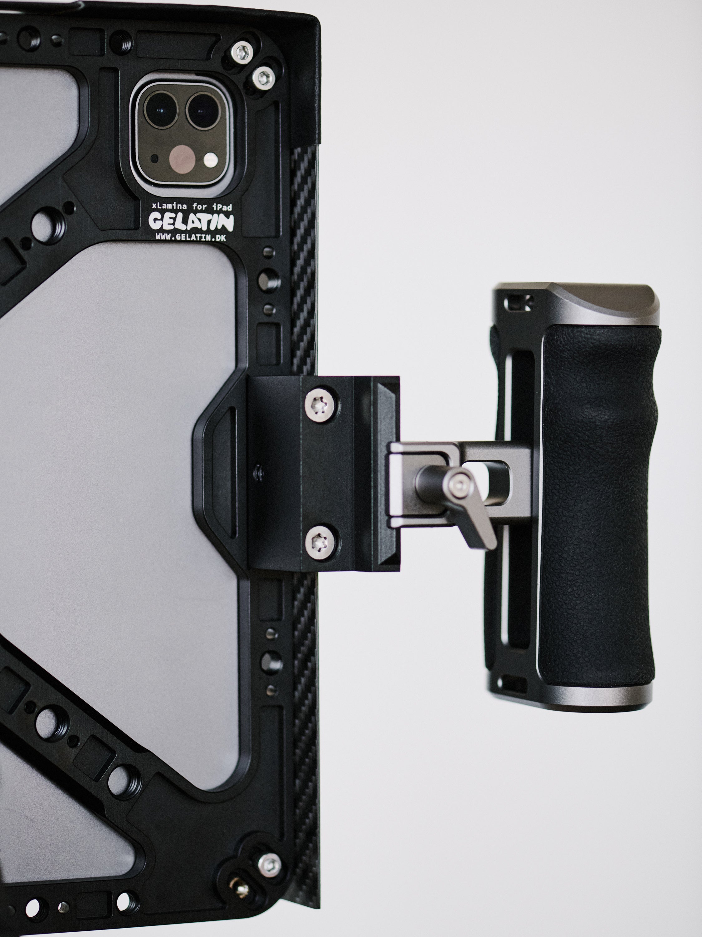 iPad Pro cage cheeseplate mounting system with 3/8"-16 screw holes for accessories including v-lock battery and NATO rail with magic arm and NATO rail handles.